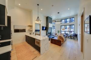 a kitchen and living room with a couch and a table at Luxe Schweitzer Condo with Hot Tub Ski-InandSki-Out! in Sandpoint