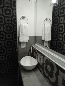 a bathroom with a bowl sink and a mirror at B&B - El Refugio -C D in Paraná