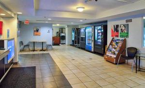 a lobby of a fast food restaurant with a table and chairs at Motel 6-Buffalo, NY - Airport - Williamsville in Williamsville