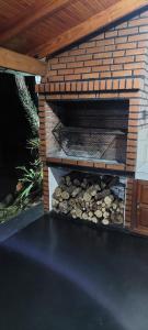 a brick oven with a pile of logs in it at Cabaña Guabiroba in Dos de Mayo