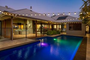 a house with a swimming pool with lights on it at Red Lotus Retreat in Mudgee