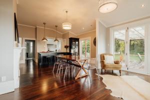 a kitchen and living room with a wooden table and chairs at View 14 in Auckland