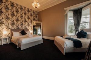 1 dormitorio con 2 camas y ventana en View 14, en Auckland