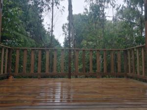 a wooden bench sitting on a wooden deck at Sanary in Guarne