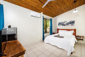 Postel nebo postele na pokoji v ubytování El Sueno Tropical