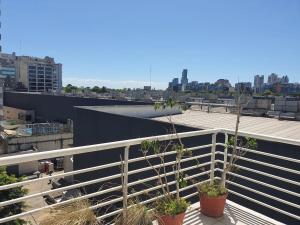 a balcony with two potted plants on top of a building at Juncal Apartamento in Buenos Aires