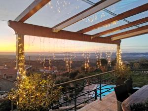a patio with a view of the ocean with christmas lights at Casa do Penedo Castle House in Linhares
