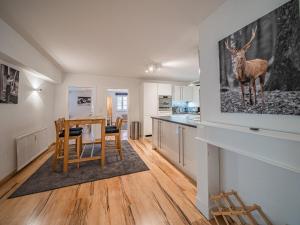 a kitchen with a table and a deer on the wall at Apartment Gorilla in Hopfgarten im Brixental