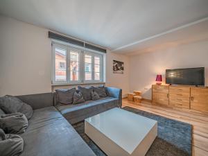 a living room with a couch and a flat screen tv at Apartment Gorilla in Hopfgarten im Brixental