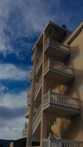 a building with balconies on the side of it at 360° View Apartments in Vlorë