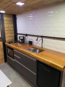 a kitchen with a sink and a counter top at Chalé Panorama in Munhoz