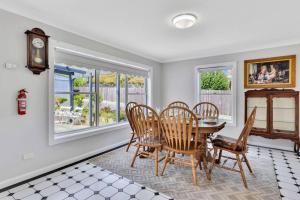 a dining room with a table and chairs and a clock at Addlestone House - St Mary's in Saint Marys