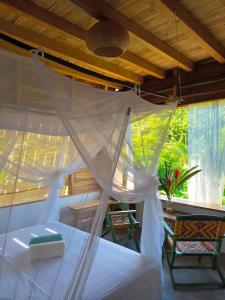 a bedroom with a bed with a mosquito net at Frana Lodge in El Zaino