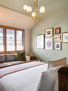 a bedroom with a large bed and a couch at Palihouse Hyde Park Village in Tampa