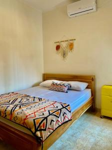 a bedroom with a bed with a comforter at GWK View villa style house in Jimbaran