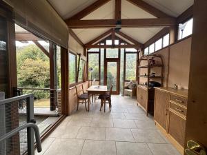 a kitchen with a table and some windows at Magnificent home in Tilf with garden in Tilff