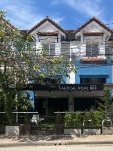 a building with a sign that readsnatural home bbb at Nautical Home B&B Khaolak in Khao Lak