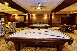 een pooltafel in een kamer met tafels en stoelen bij San Luis Sunrise in Galveston