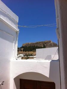 a view of a white building with a mountain in the background at Villa Soultana in Lindos