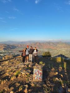 a group of people standing on top of a mountain at Backpackers House - Near The Airport in Santiago