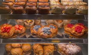 a display case filled with lots of pastries and croissants at Meeting House in Falls Church