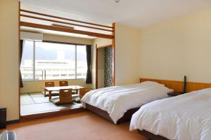 Postel nebo postele na pokoji v ubytování Ooedo Onsen Monogatari Beppu Seifu + 37 fotografií