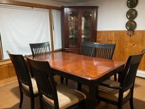 a dining room with a wooden table and chairs at Comfortable place to stay in Milford