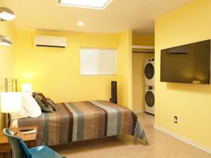 a bedroom with a bed and a television in it at Guesthouse w/ private access and patio in Tucson