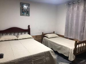 Ένα ή περισσότερα κρεβάτια σε δωμάτιο στο Casa Palmeira