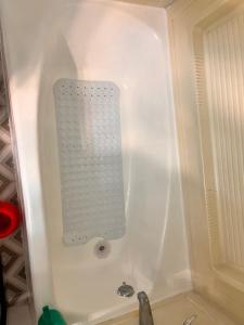 a bath tub with a shower in a room at Two Bedroom Apartment In Cheektowaga in Cheektowaga +45 photos
