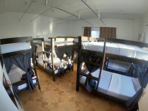 a group of bunk beds in a room at Alec Lodge in Coron