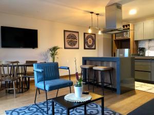 a kitchen and living room with a table and chairs at La Primera en La Candelaria in Bogotá