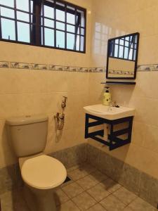 a bathroom with a toilet and a sink at Pleasant Stay @ Sunway (16-20 pax ) 5 min to Lost World of Tambun in Tambun