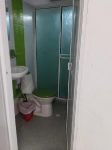 a bathroom with a toilet and a sink at Cabañas Chavita PISO 1 Coveñas in Coveñas +4 photos