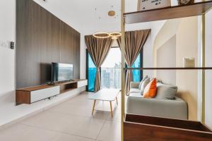 a living room with a couch and a television at Nowhere 2BR & 2Bath Apartment with Balcony @ Reizz Residences in Kuala Lumpur