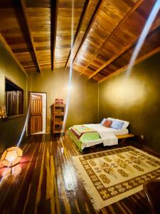 a bedroom with a bed and a wooden ceiling at Kalis Inn in Alto Paraíso de Goiás