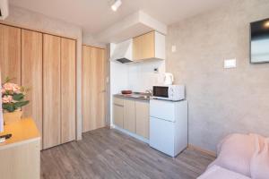 een kleine keuken met een witte koelkast en een magnetron bij New Designed apart ment Shin-Okubo Sta 3 min walk in Tokyo
