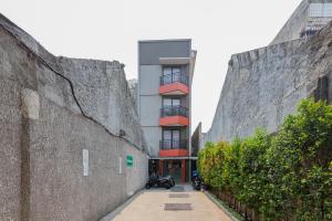 a building with motorcycles parked next to a wall at Urbanview Hotel Slipi Inn Palmerah in Jakarta