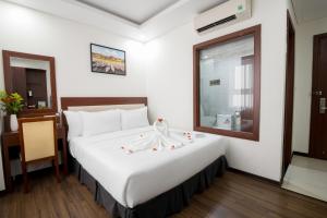 Letto o letti in una camera di Dao Ngoc Hotel Da Nang