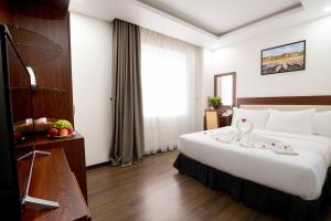 Letto o letti in una camera di Dao Ngoc Hotel Da Nang