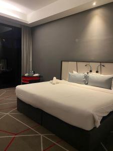 a bedroom with a large bed with a large white bedspread at Studio Bedroom with Balcony in Kuala Lumpur