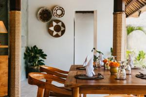 a wooden table in a room with a dining at Sri Phala Resort & Villa in Sanur