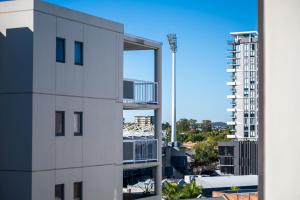 a white building with a balcony on the side of it at Urban Luxury City Apartment with Pool and Parking in Brisbane