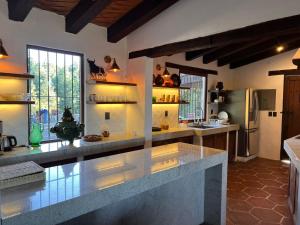 a large kitchen with a large island in a room at Villa del Lago in Pátzcuaro
