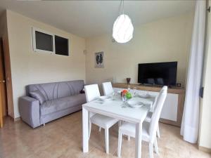 a living room with a white table and a couch at Apartamento en el Centro de Platja d'Aro con Piscina, Terraza y Cerca de la Playa - ES-209-45 in Platja  d'Aro