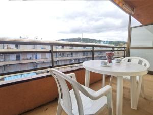 a white table and two chairs on a balcony at Apartamento en el Centro de Platja d'Aro con Piscina, Terraza y Cerca de la Playa - ES-209-45 in Platja  d'Aro
