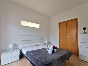 a bedroom with a bed and a wooden cabinet at Apartamento en el Centro de Platja d'Aro con Piscina, Terraza y Cerca de la Playa - ES-209-45 in Platja  d'Aro +2 photos