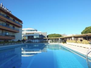 a large swimming pool in front of a building at Apartamento en el Centro de Platja d'Aro con Piscina, Terraza y Cerca de la Playa - ES-209-45 in Platja  d'Aro