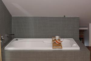 a bath tub with a candle sitting on top of it at Warburton's Loft in Melbourne