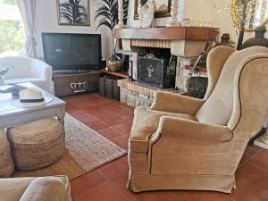 a living room with a chair and a fireplace at Casa Caldes de Malavella, 5 dormitorios, 10 personas - ES-209-37 in Caldes de Malavella